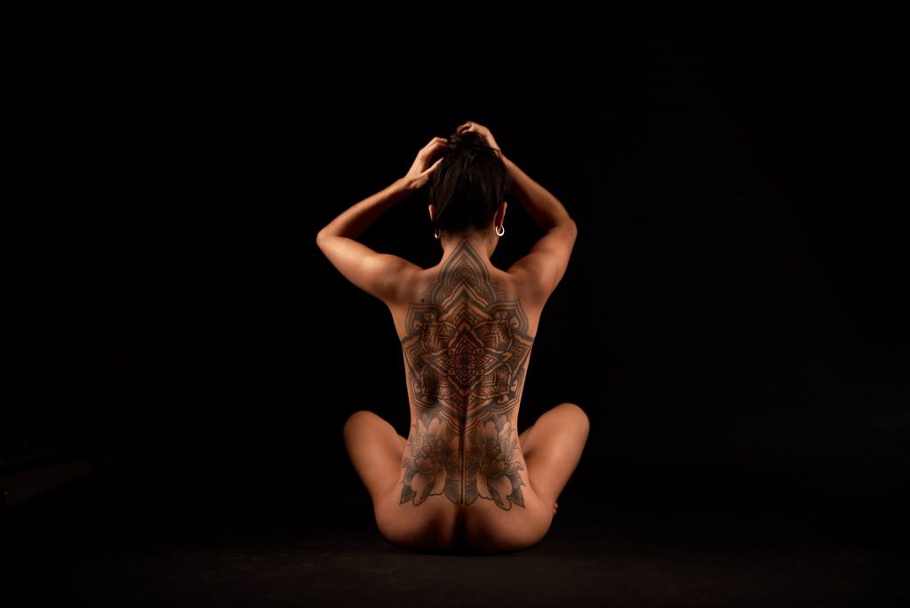 Boudoir- seated nude woman with back tattoo