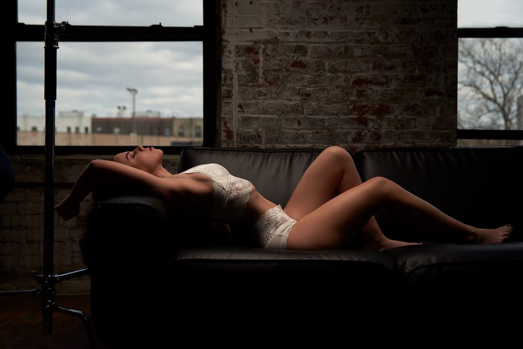 Boudoir- woman in white reclining on couch